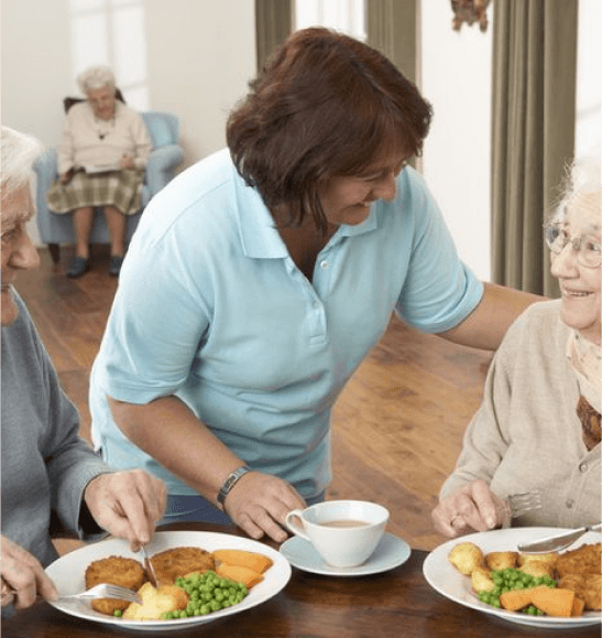 Staff serving meals to residents